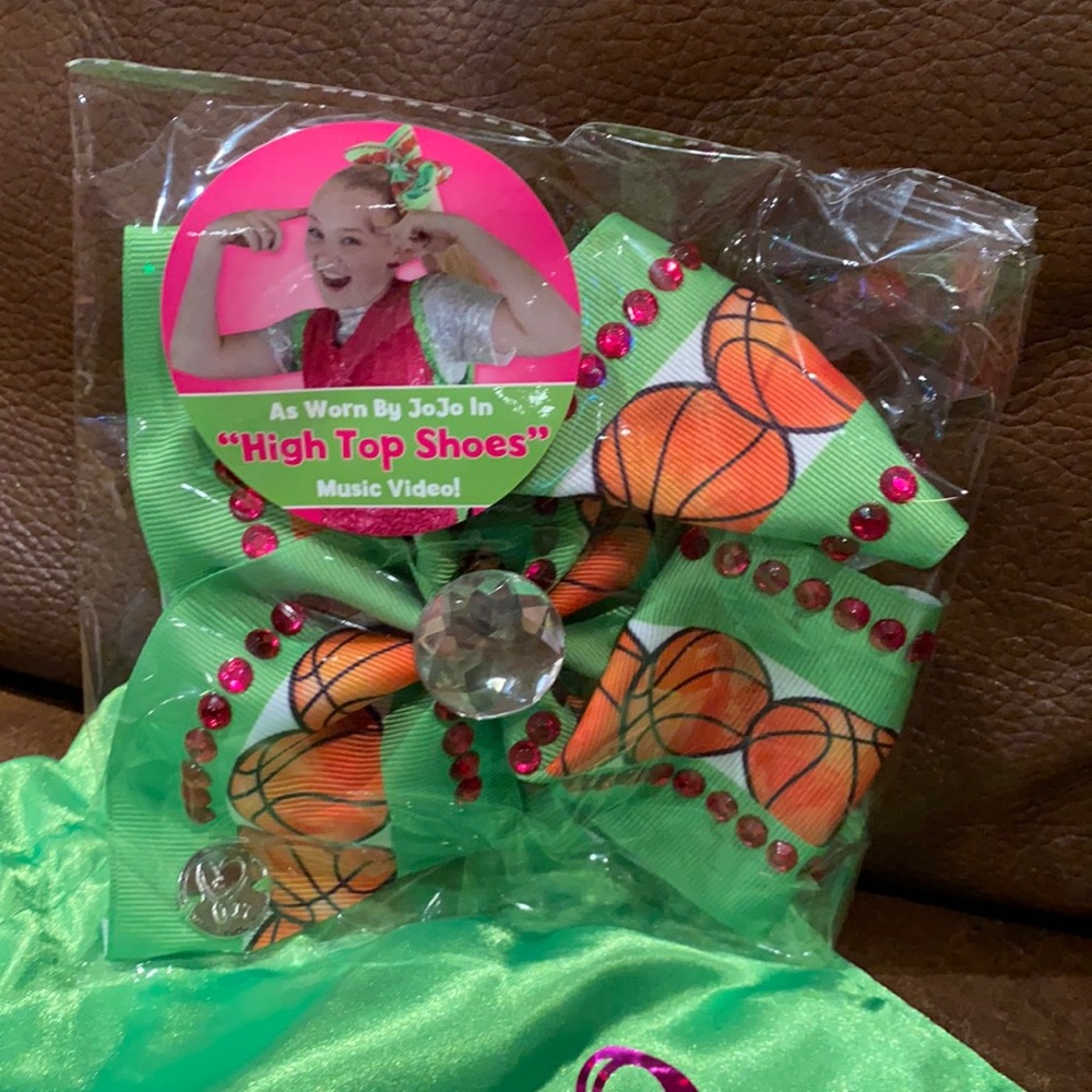 JoJo Siwa bow, pin and shoe charms. Never used.  All in brand new box.
